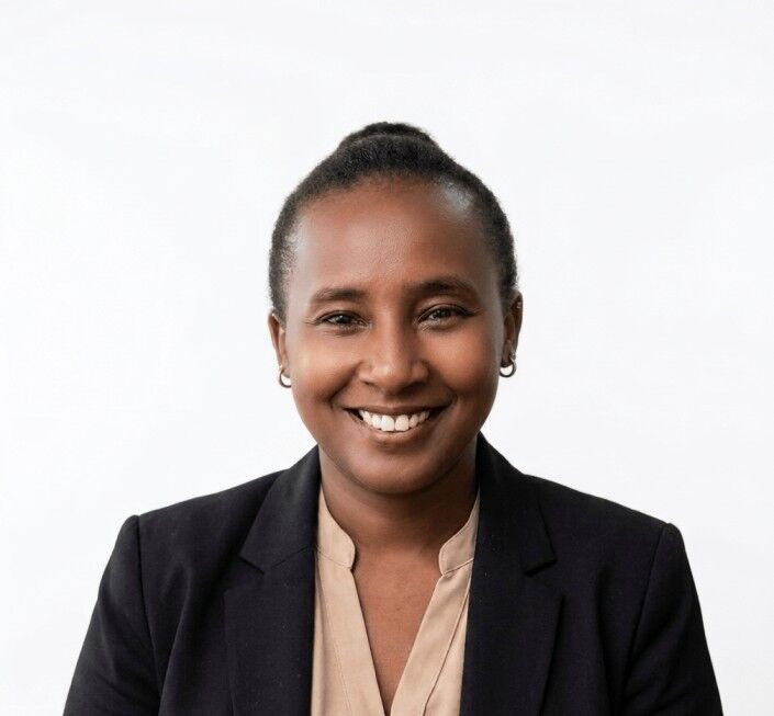 Nereas Joy Ng'endo Gitahi - Administrative Assistant Diploma Success Story Nereas Joy Ng'endo Gitahi, Pitman Training Kenya Administrative Assistant Diploma graduate, smiling in a black blazer